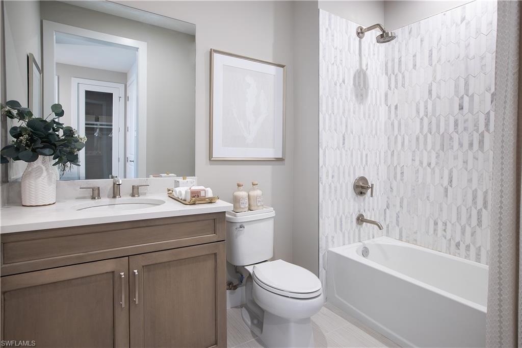 8909 Oceana Way Naples, FL 34114 - Photo 8 of 41 a bathroom with a sink a toilet and shower