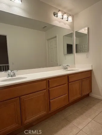 a bathroom with a double vanity sink and mirror