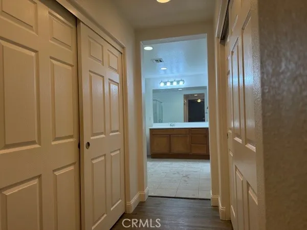 a bathroom with a glass door shower and a sink