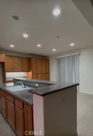 a kitchen with stainless steel appliances granite countertop a sink and a white cabinets