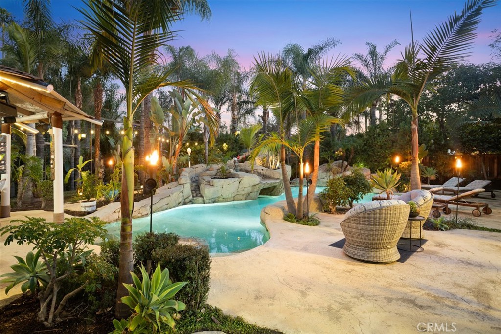 a view of a street with potted plants and palm trees