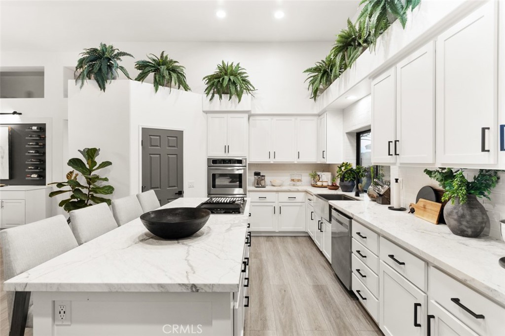 2531 Cottage Drive Corona, CA 92881 - Photo 14 of 48 a kitchen with a white table and chairs