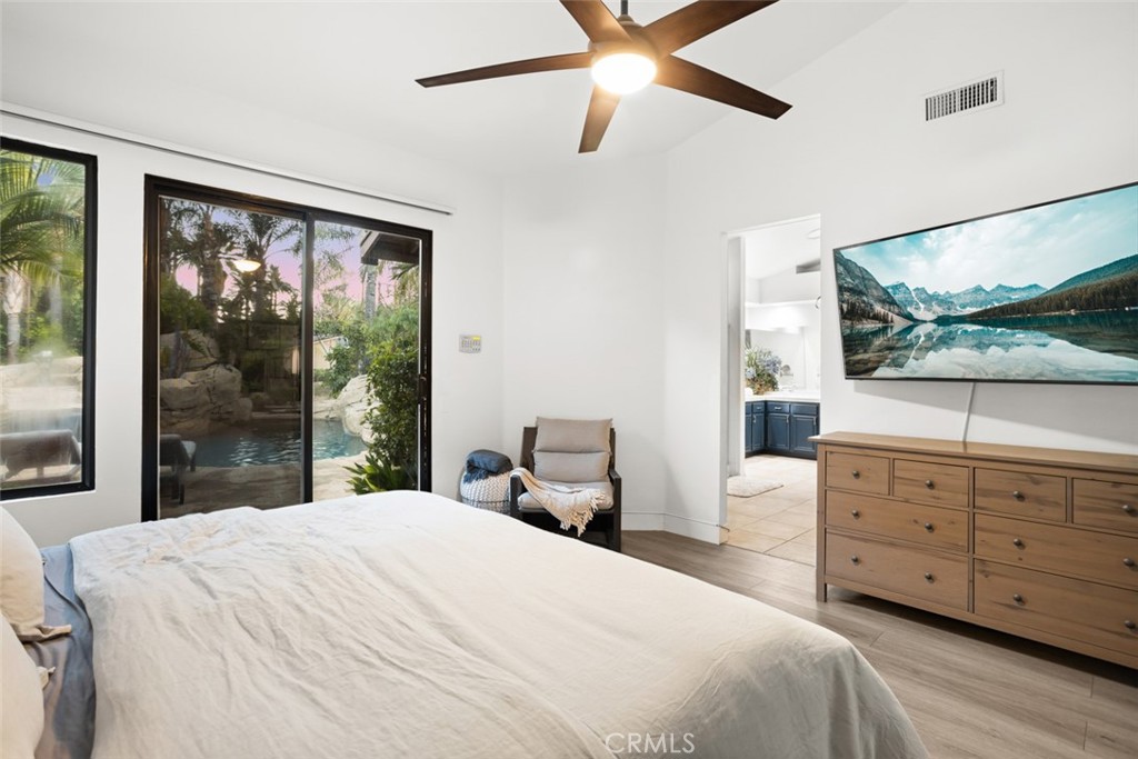 2531 Cottage Drive Corona, CA 92881 - Photo 22 of 48 a bedroom with a bed and large windows