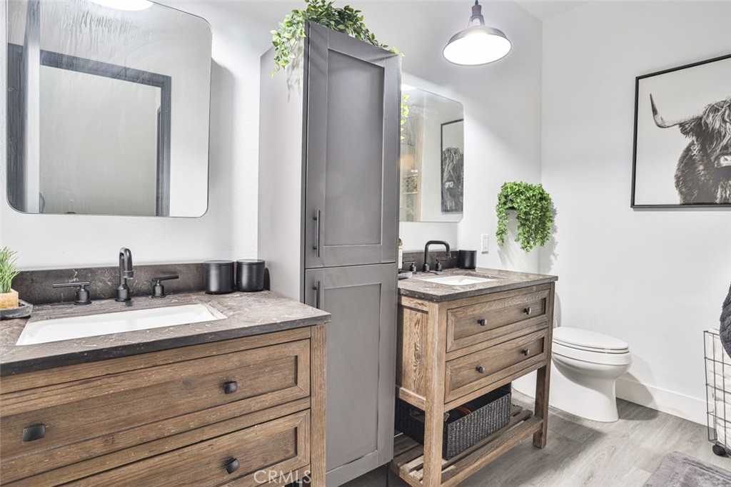 2531 Cottage Drive Corona, CA 92881 - Photo 30 of 48 a bathroom with a granite countertop sink mirror vanity and toilet