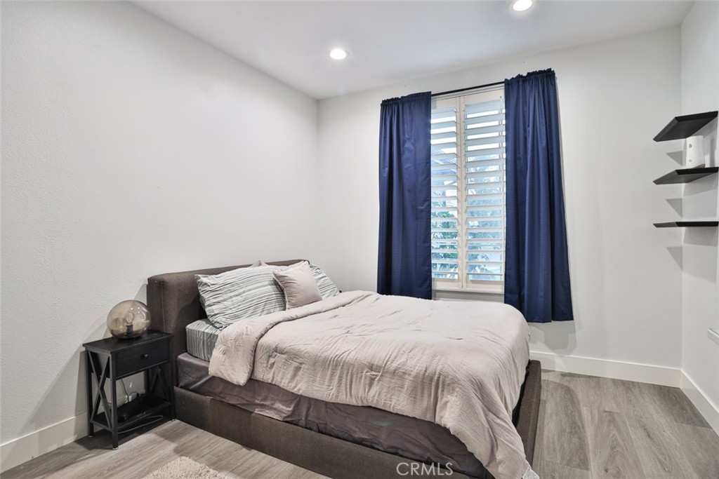 2531 Cottage Drive Corona, CA 92881 - Photo 32 of 48 a bedroom with a bed and wooden floor