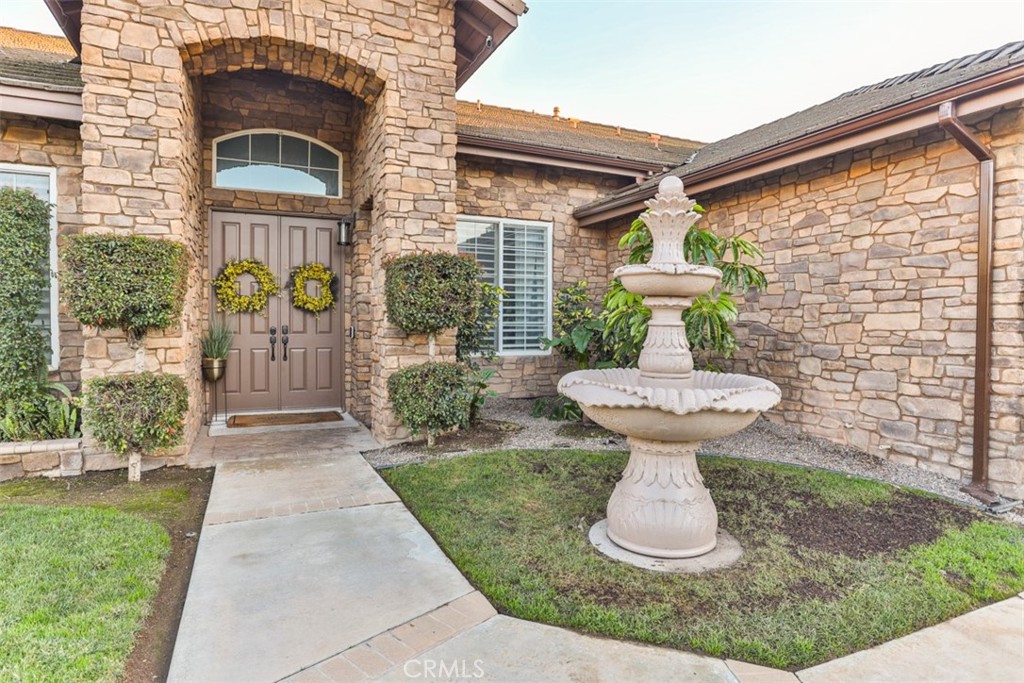 2531 Cottage Drive Corona, CA 92881 - Photo 43 of 48 a front view of a house with a yard and fountain
