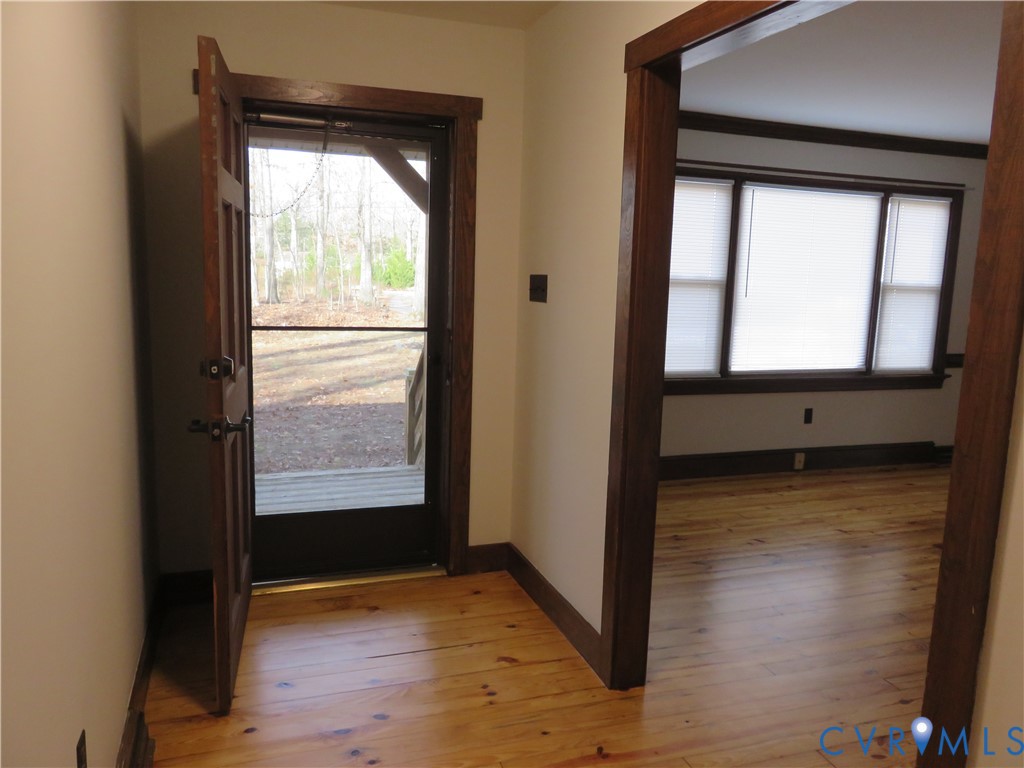 4261 Old Buckingham Road Powhatan, VA 23139 - Photo 3 of 23 a view of an empty room with wooden floor and a window