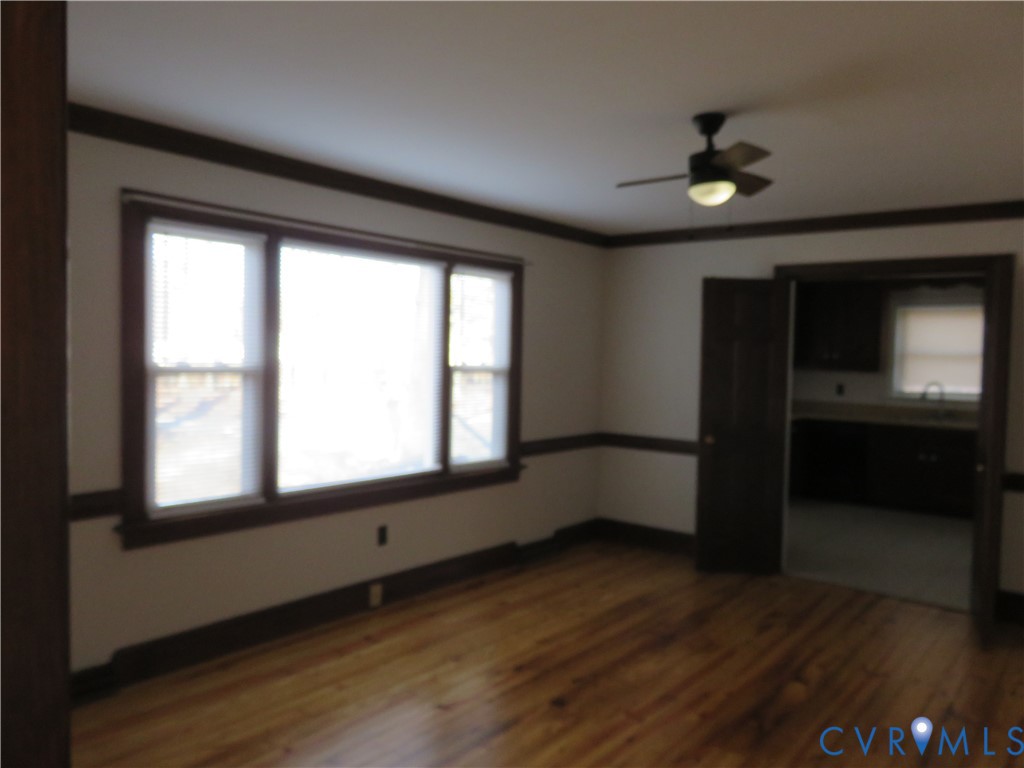 4261 Old Buckingham Road Powhatan, VA 23139 - Photo 4 of 23 a view of an empty room with a window and wooden floor