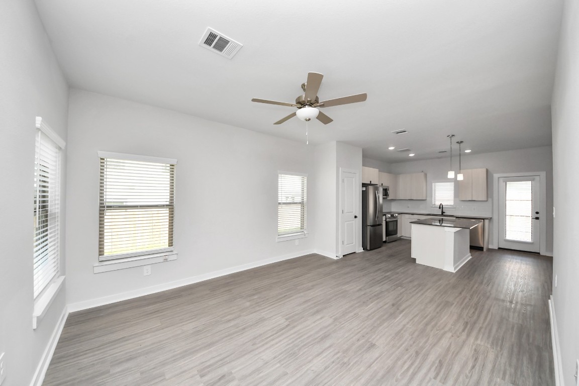 7711 Longmire Road, Unit 5 Conroe, TX 77304 - Photo 43 of 48 Boasting luxury finishes-stylish Island kitchen,granite counters,subway tile backsplash,ample custom cabinet space,stainless appliances,refrigerator,full size washer&dryer included,wood-like flooring throughout,open concept floor plan.