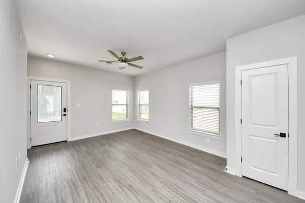 a very nice looking living room with a large window and a table