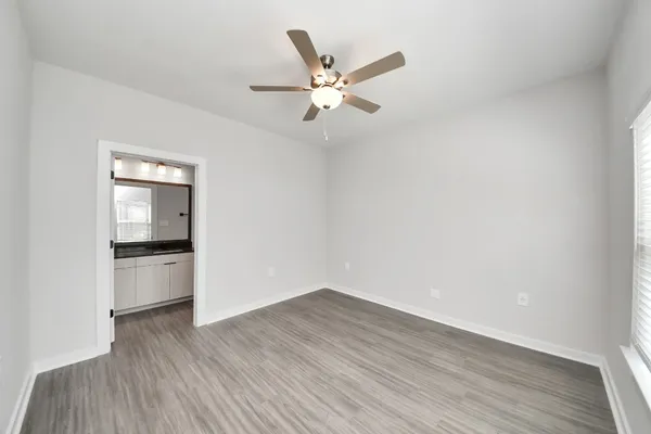 a kitchen with a refrigerator and wooden floor