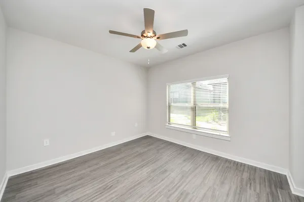 a kitchen with stainless steel appliances granite countertop white cabinets a sink and a stove