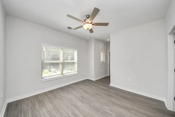 a kitchen with stainless steel appliances a refrigerator a stove and white cabinets