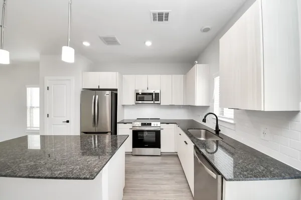 a kitchen with a sink and cabinets