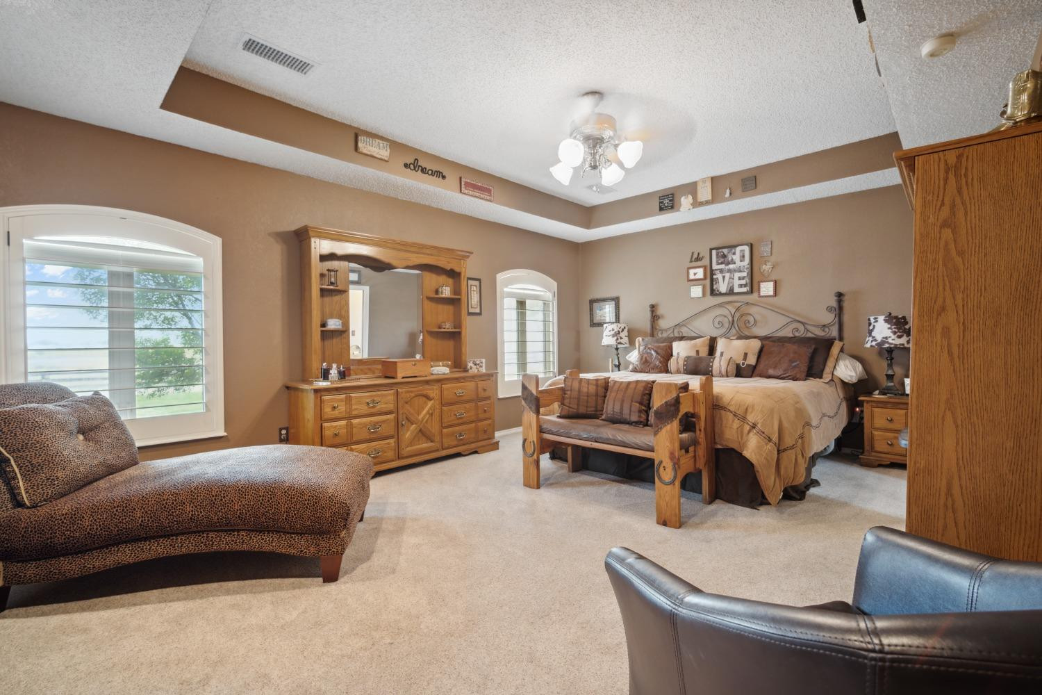 9002 Woodrow Road Wolfforth, TX 79382 - Photo 10 of 48 a bedroom with a large bed and furniture