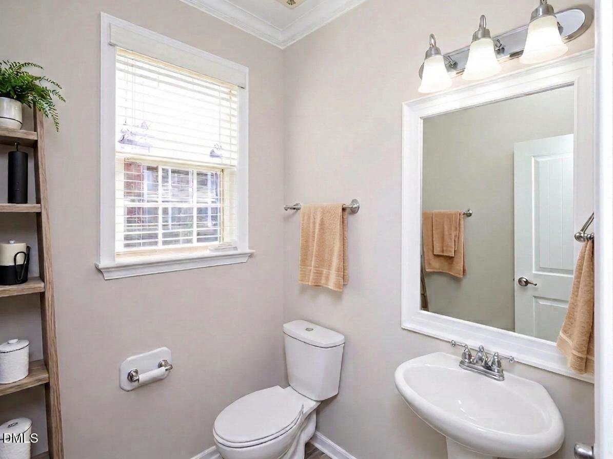 1314 Still Monument Way Raleigh, NC 27603 - Photo 11 of 25 a bathroom with a granite countertop toilet a sink and a mirror