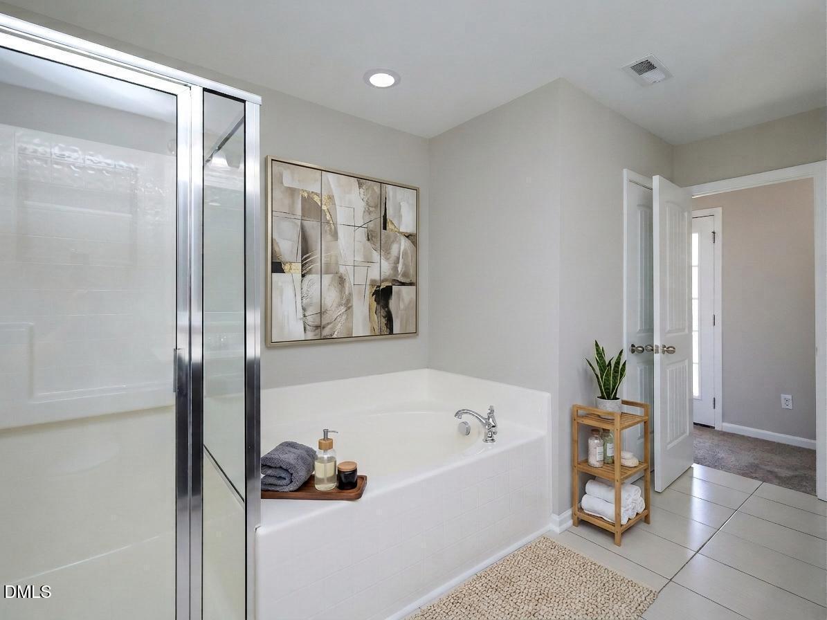 1314 Still Monument Way Raleigh, NC 27603 - Photo 14 of 25 a bathroom with a tub and a shower