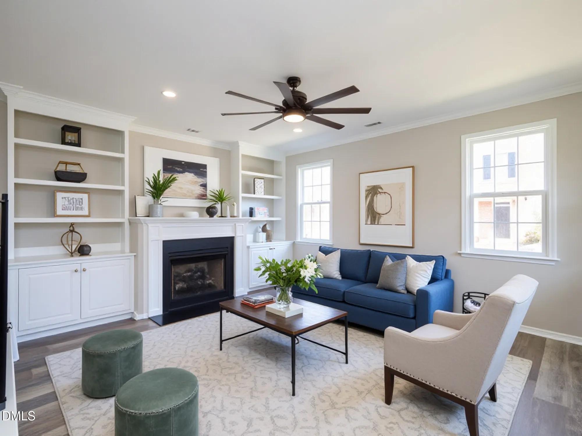 1314 Still Monument Way Raleigh, NC 27603 - Photo 3 of 25 a living room with furniture a flat screen tv and a fireplace