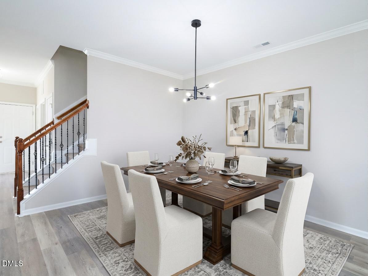1314 Still Monument Way Raleigh, NC 27603 - Photo 5 of 25 a view of a dining room with furniture wooden floor and a chandelier