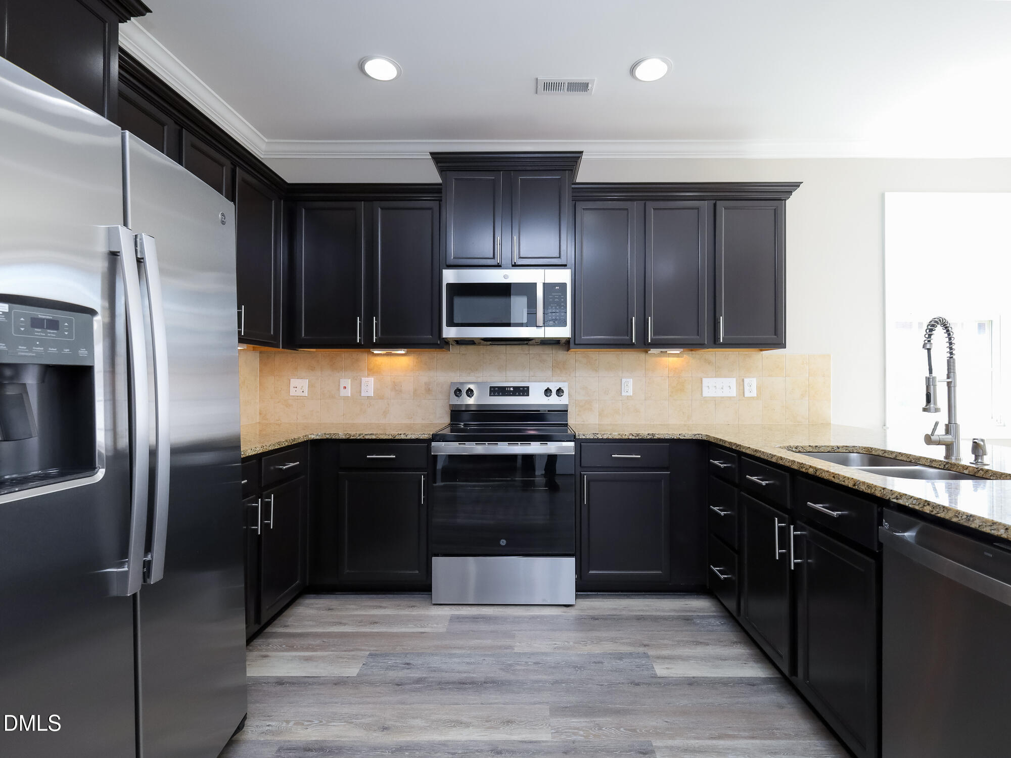 1314 Still Monument Way Raleigh, NC 27603 - Photo 7 of 25 a kitchen with a refrigerator stove and sink