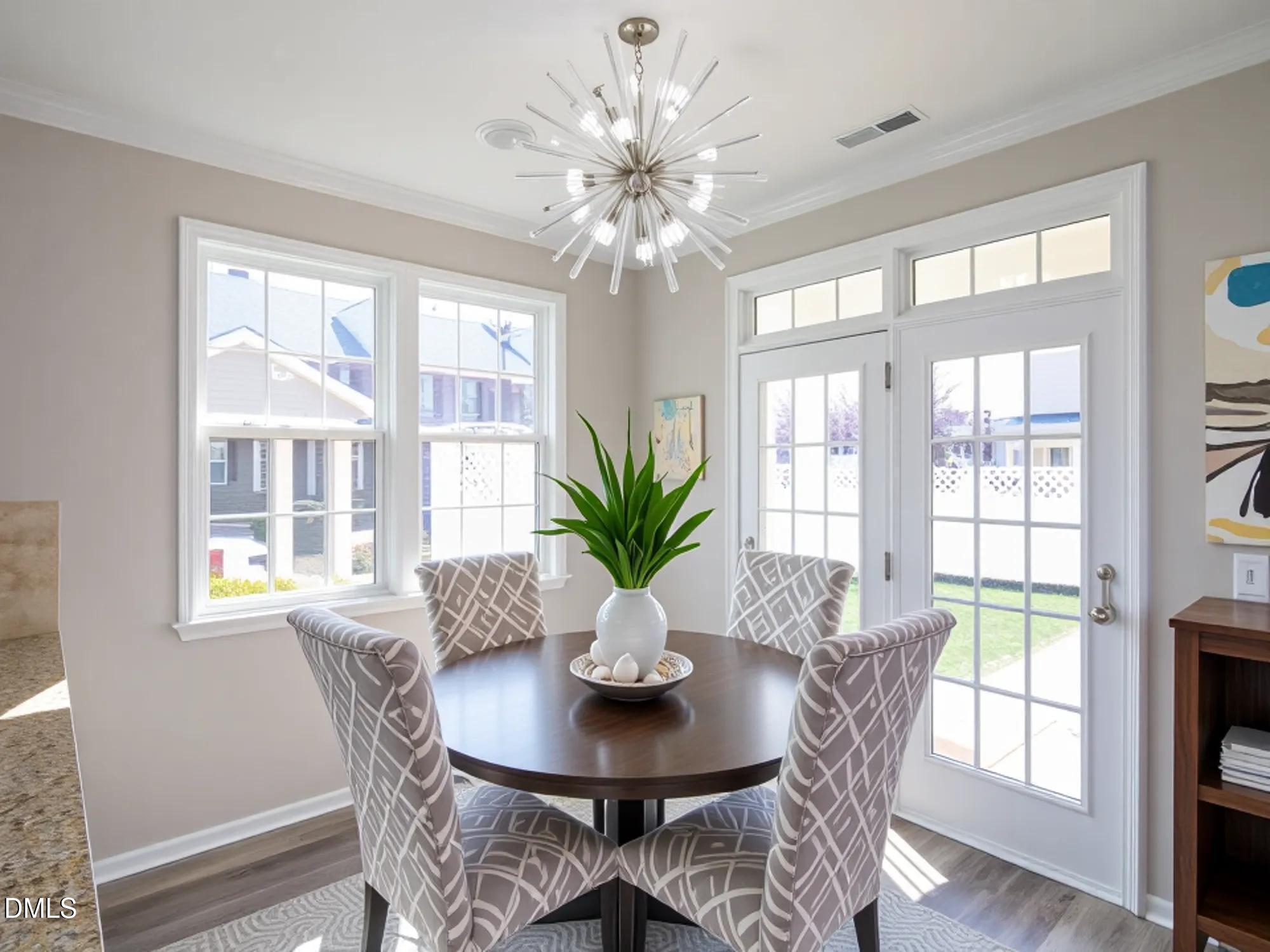 1314 Still Monument Way Raleigh, NC 27603 - Photo 10 of 25 a view of a dining room with furniture window and wooden floor