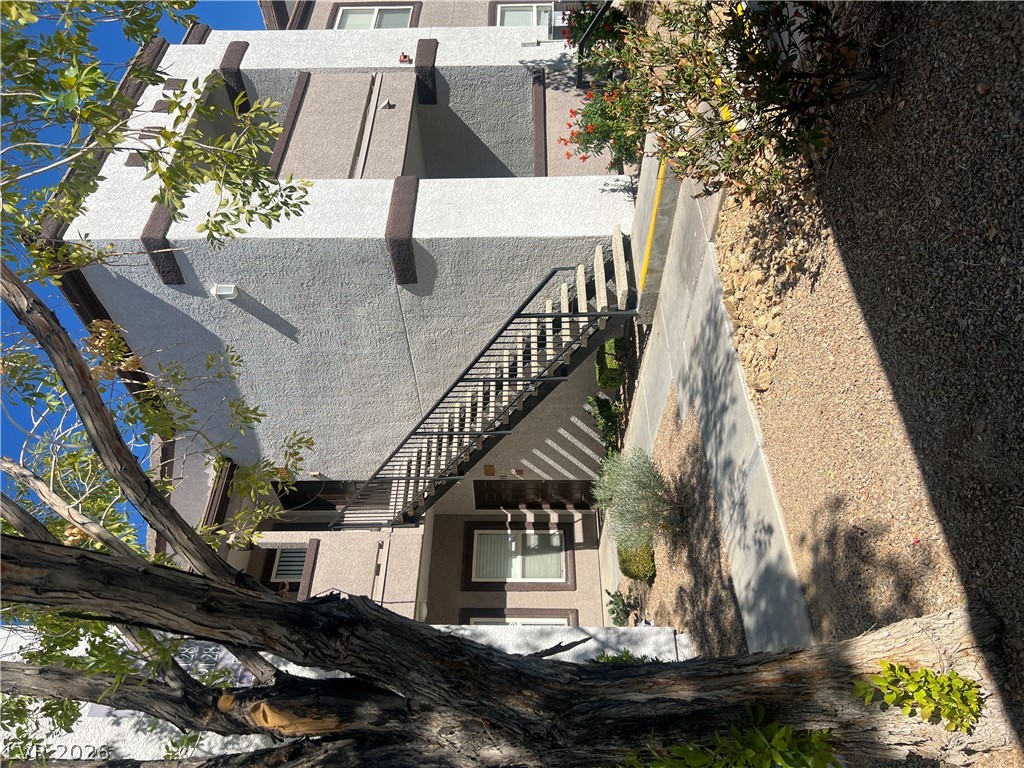7255 West Sunset Road, Unit 2057 Las Vegas, NV 89113 - Photo 1 of 12 Mature trees and landscaping frame this multi-story residence with convenient exterior access.