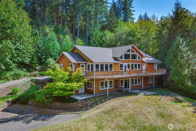 a aerial view of a house with a yard and potted plants