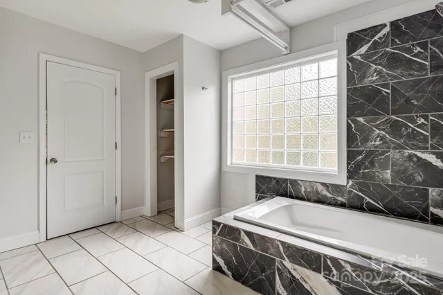 a bathroom with a bathtub and window