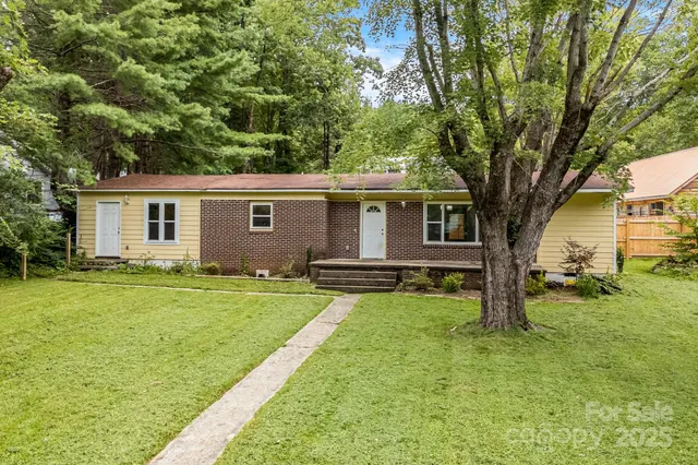 a view of a house with a backyard