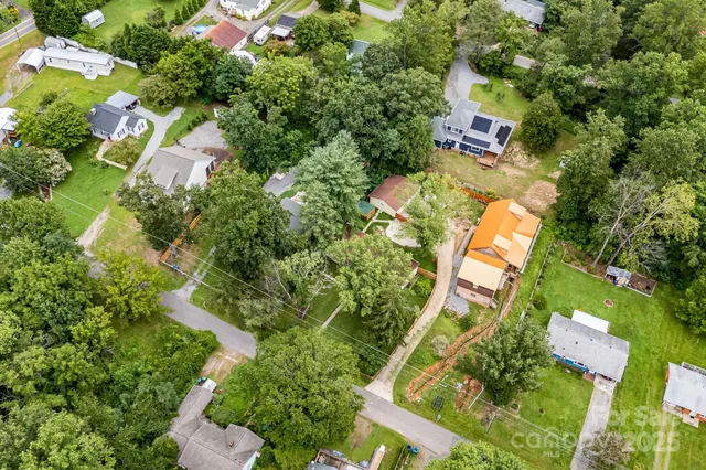 an aerial view of a house with swimming pool and garden
