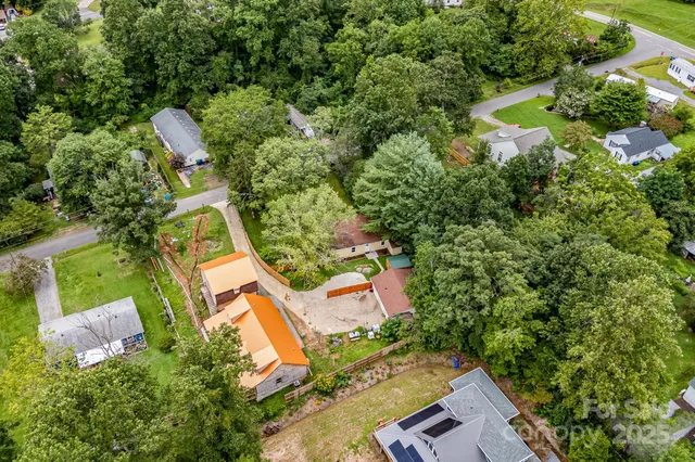 an aerial view of a house with a yard and outdoor seating