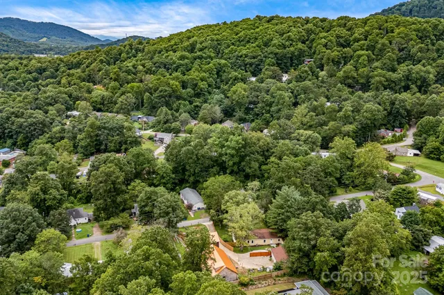 an aerial view of a house with a yard