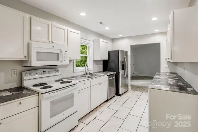 a kitchen with a stove a sink and a refrigerator
