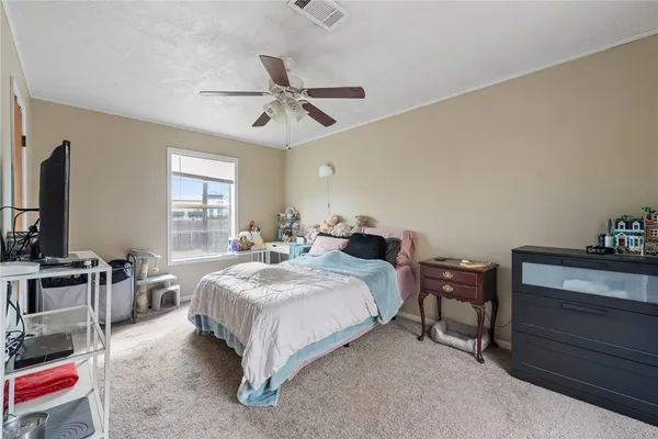 a spacious bedroom with a bed and a table in it