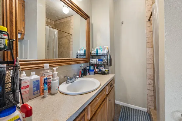a bathroom with a sink vanity and a mirror