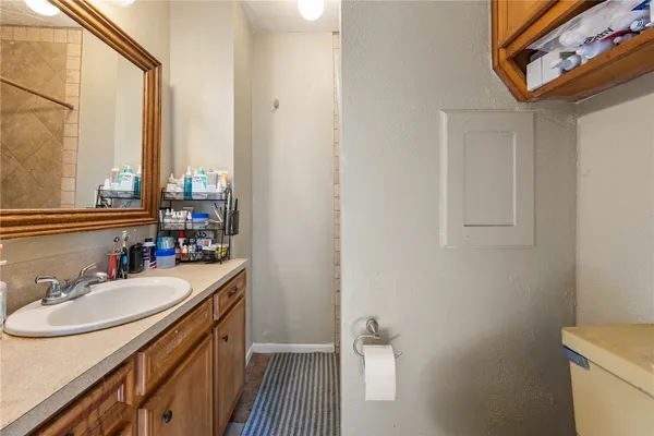 a bathroom with a sink a toilet and a mirror