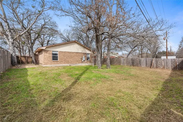 a view of a yard with a house and tree s