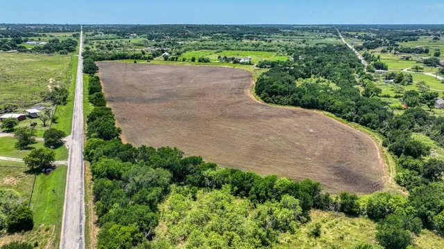 an aerial view of a residential houses with outdoor space and garden