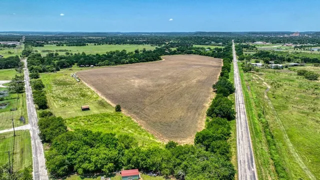 an aerial view of a houses with a yard