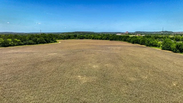 a view of a field with ocean view