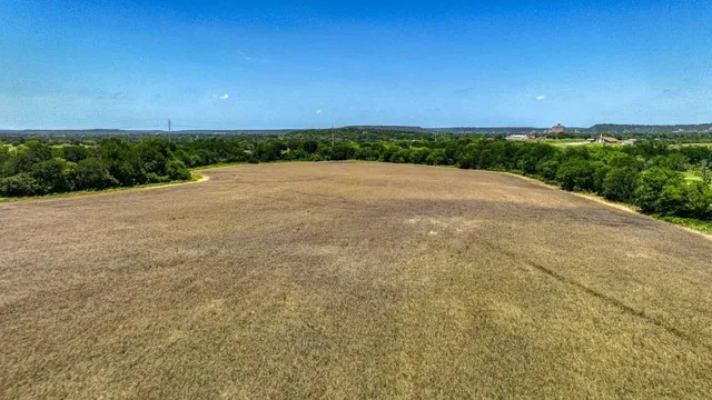 a view of a big yard with large trees