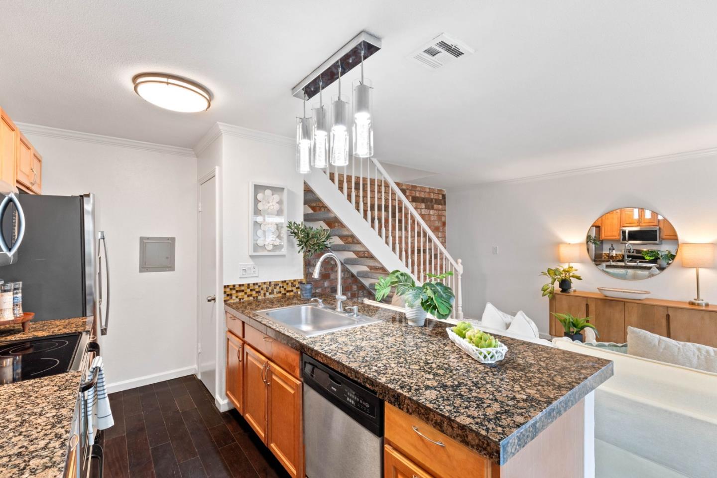 5536 Spinnaker Drive, Unit 3 San Jose, CA 95123 - Photo 17 of 30 a kitchen with granite countertop a sink a stove and a wooden cabinets