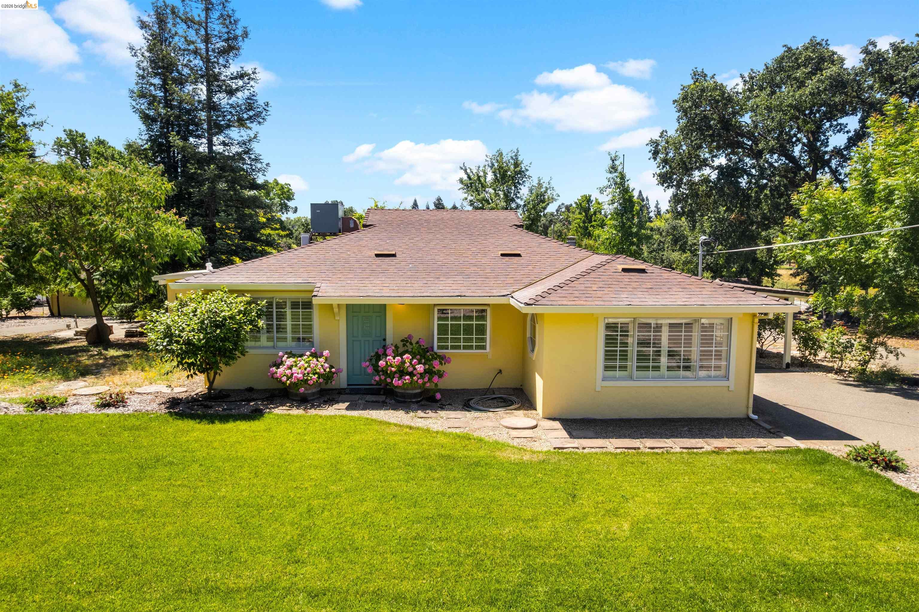 10474 Sheldon Road Elk Grove, CA 95624 - Photo 1 of 83 Yellow exterior with a brown shingle roof