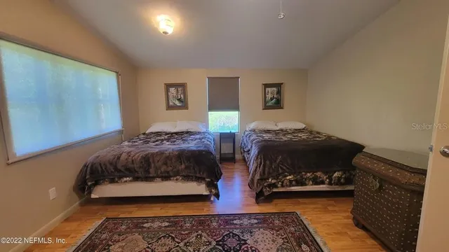 a bedroom with double bed and a couch