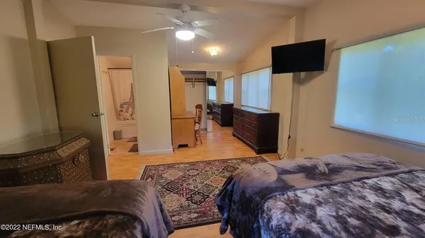 a bedroom with a bed and flat screen tv