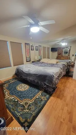 a bedroom with a bed rug and dresser