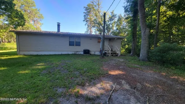 a view of a backyard with a large tree