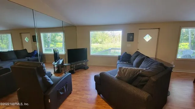 a living room with furniture and a flat screen tv