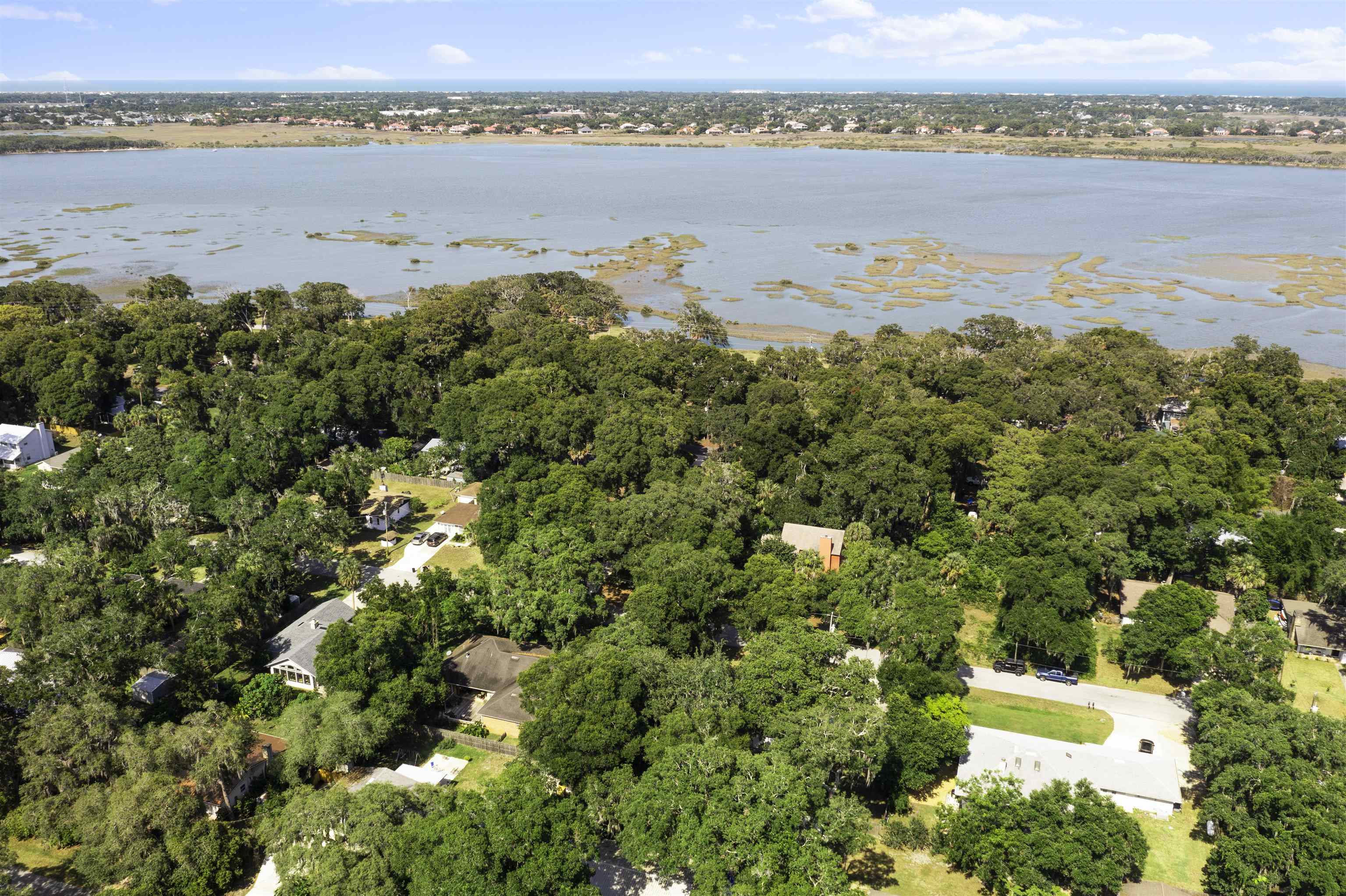 246 Mimosa Road St. Augustine, FL 32086 - Photo 11 of 45 a view of a lake with a building in the background