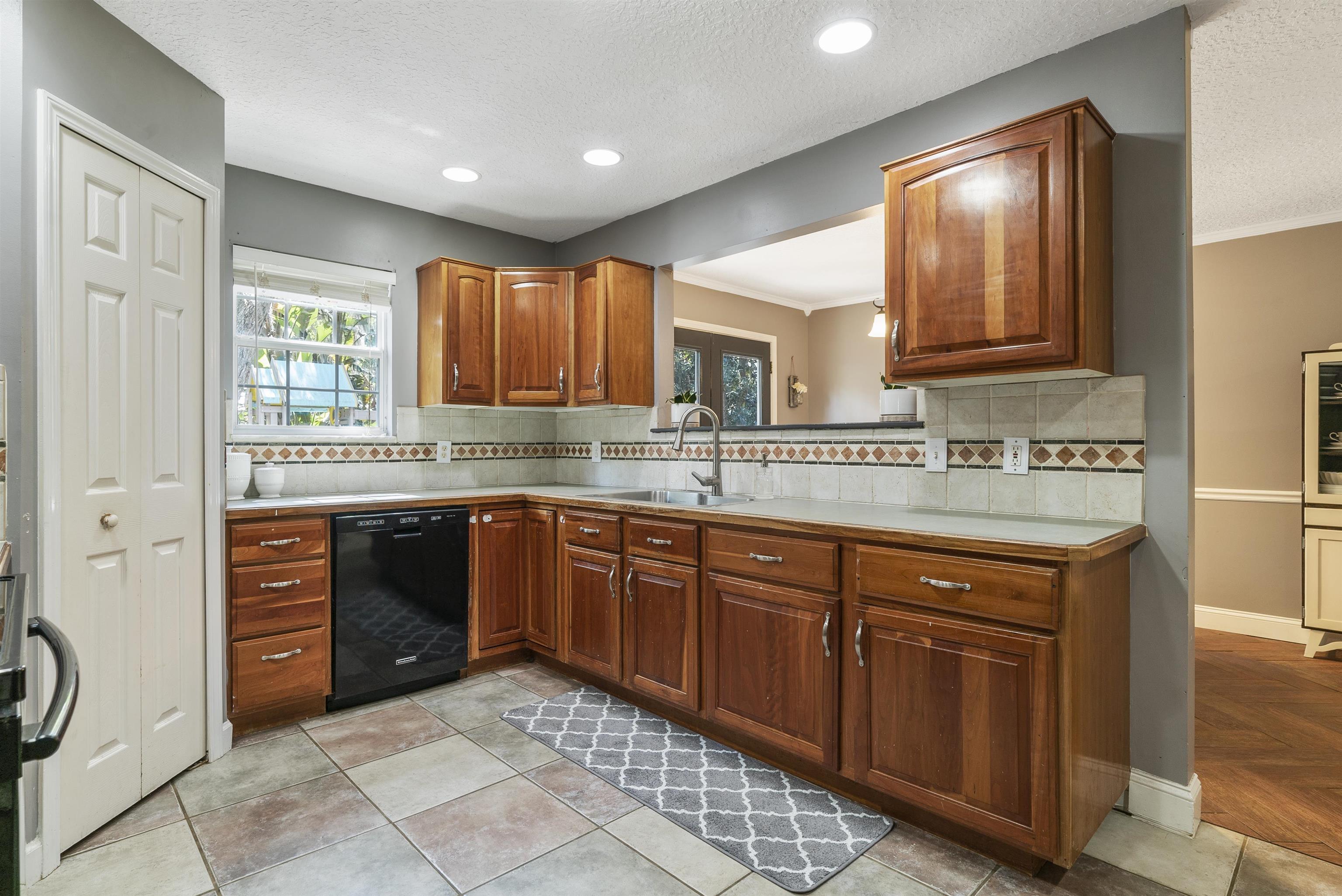 246 Mimosa Road St. Augustine, FL 32086 - Photo 20 of 45 a kitchen with stainless steel appliances granite countertop wooden cabinets a sink and dishwasher